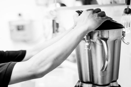 making gelato ice cream with modern professional equipment preparation detail in kitchen interior black and white photo