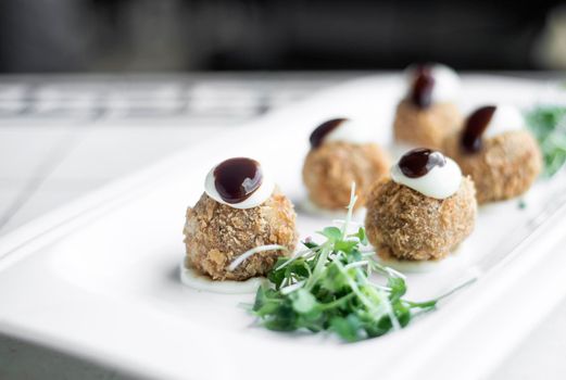 gourmet organic scotch quail eggs modern starter snack dish on table