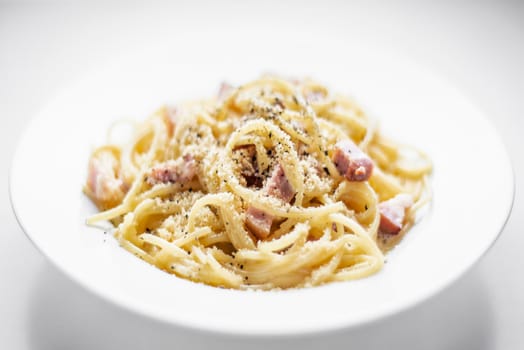 spaghetti pasta carbonara with bacon ham cream and kampot pepper dish