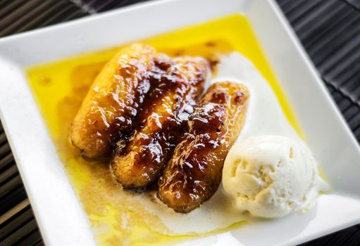 asian fried banana and sugar cane caramel dessert with coconut ice cream