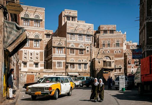 street scene and local heritage architecture buildings in old town of sanaa yemen