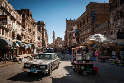 street scene and local heritage architecture buildings in old town of sanaa yemen