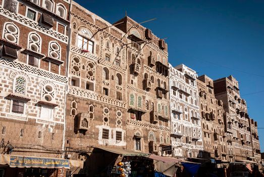 street scene and local heritage architecture buildings in old town of sanaa yemen