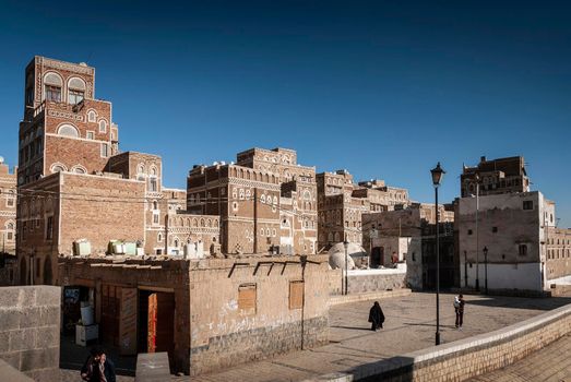 street scene and local heritage architecture buildings in old town of sanaa yemen