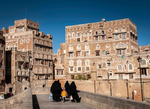 street scene and local heritage architecture buildings in old town of sanaa yemen