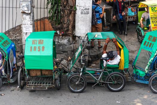 tricycle pedicabs local transport in downtown intramuros street of manila city philippines