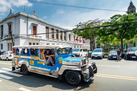 jeepney bus local transport traffic in downtown manila city street in philippines