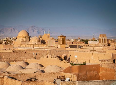 downtown rooftops wind towers and landscape view of yazd city old town in iran