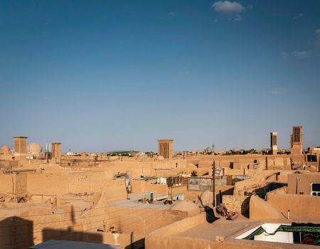 downtown rooftops wind towers and landscape view of yazd city old town in iran