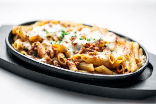 gourmet oven baked fresh pasta penne bolognese and mozzarella cheese dish