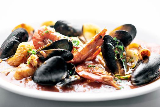 sicilian mixed fresh seafood stew with prawns mussels scallops and clams in spicy tomato sauce