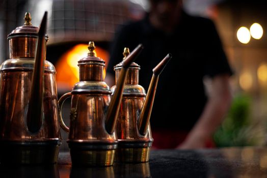 classic olive oil copper cruet traditional dispenser detail in italian restaurant