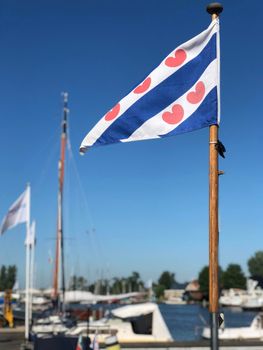 Frisian flag in the harbor of Grou, Friesland The Netherlands