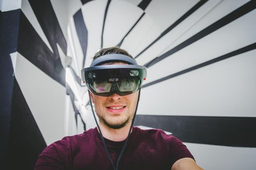 Young man is using virtual reality glasses or headset