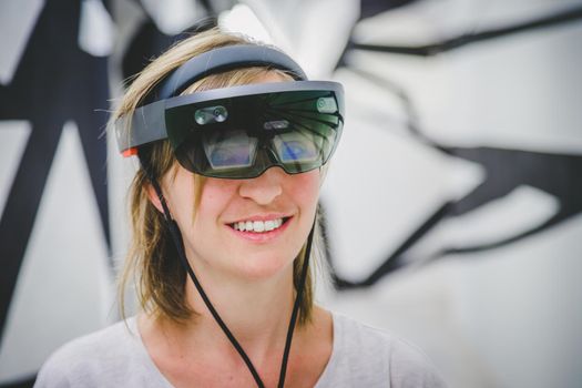 Young woman is using virtual reality glasses or headset