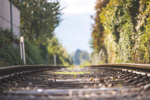 Landscape of an old abandoned railway in fall. Warm light, sustainable traveling