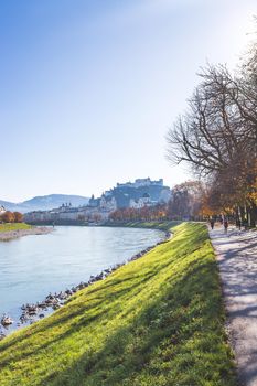 Salzburg historic district and the river salzach in autumn time, colorful leaves and colors with sunshine, Austria