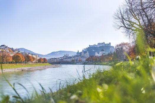 Salzburg historic district and the river salzach in autumn time, colorful leaves and colors with sunshine, Austria
