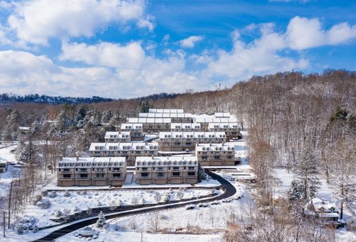 View of modern townhouses covered with winter snow on hill overlooking Cheat Lake near Morgantown West Virginia