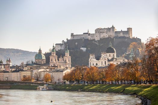 Salzburg historic district and the river salzach in autumn time, colorful leaves and colors with sunshine, Austria
