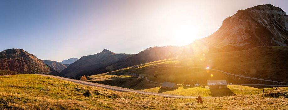 Beautiful scenic mountain scenery with huts and warm colors, sundown