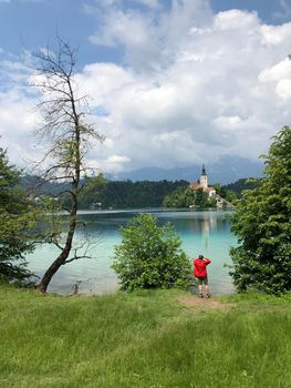 Tourist taking a picture from Bled island in Slovenia