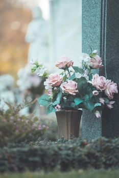 Close up of beautiful roses on a grave at a cemetery