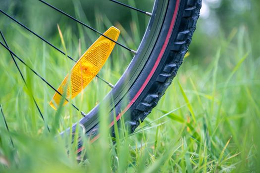 Close up picture of a mountain bike tire in the grass, summer day
