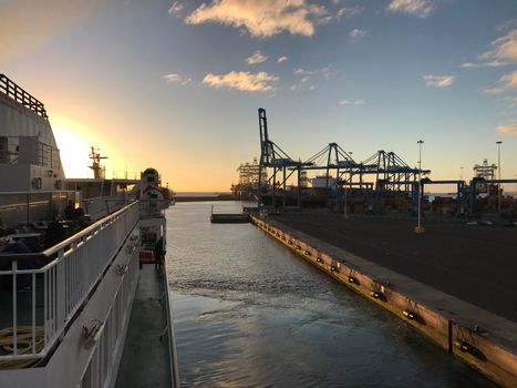 Ferry leaving Las Palmas harbour in Gran Canaria during sunrise