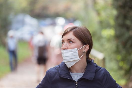 Young woman is wearing face mask wrong, nose uncovered