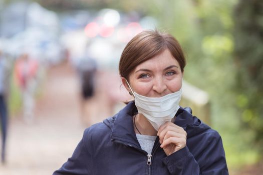 Young woman is wearing face mask wrong, nose uncovered