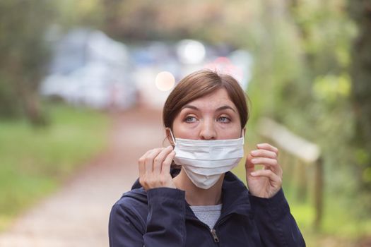 Young woman is wearing face mask wrong, nose uncovered