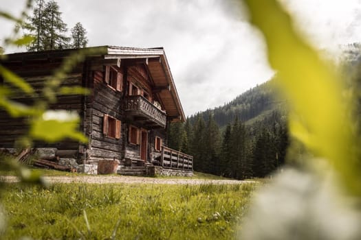 Mountain chalet and cloudy sky in Austria: Idyllic landscape in the Alps