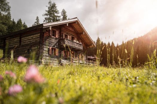 Mountain chalet and cloudy sky in Austria: Idyllic landscape in the Alps