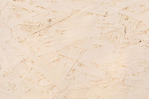 Fragments of glued boards from wood chips. Chipboard beige, wood texture. Wood recycling concept
