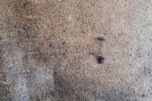 Light background with small drops of black paint and damaged surface. Abstract art woody background. Material - plywood.
