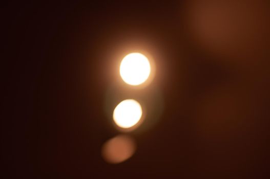 light from a source of yellow lanterns on a dark background