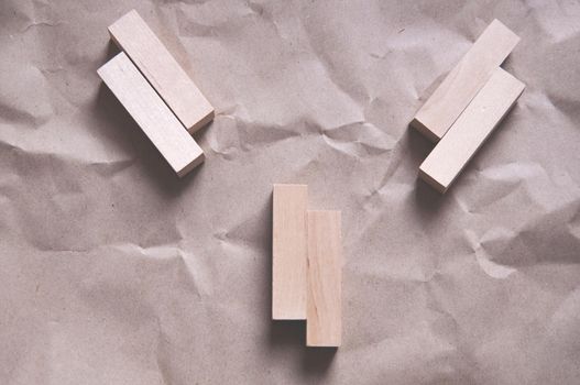 background of crumpled craft paper with wooden rectangles arranged in a certain order in a minimalist style