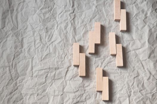 background of crumpled craft paper with wooden rectangles arranged in a certain order in a minimalist style