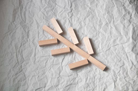 background of crumpled craft paper with wooden rectangles arranged in a certain order in a minimalist style