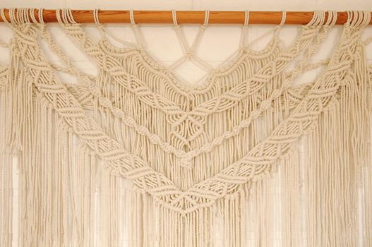 Macrame pattern. A minimal, stylish, trendy concept with a beautiful background with light neutral colors.
