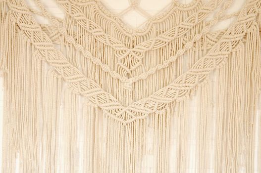 Macrame pattern. A minimal, stylish, trendy concept with a beautiful background with light neutral colors.