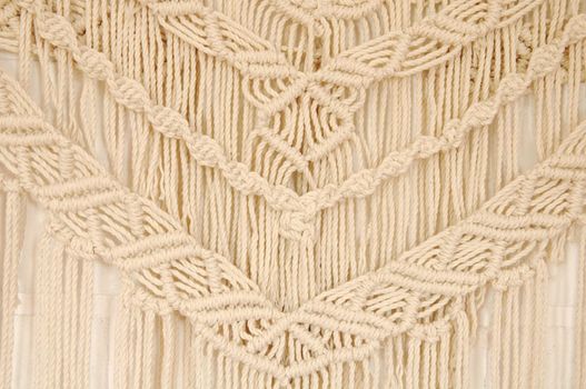 Macrame pattern. A minimal, stylish, trendy concept with a beautiful background with light neutral colors.