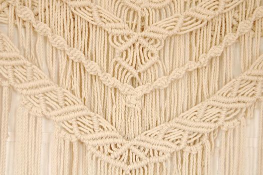 Macrame pattern. A minimal, stylish, trendy concept with a beautiful background with light neutral colors.