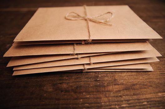 Correspondence from kraft paper on a wooden background tied with a rope