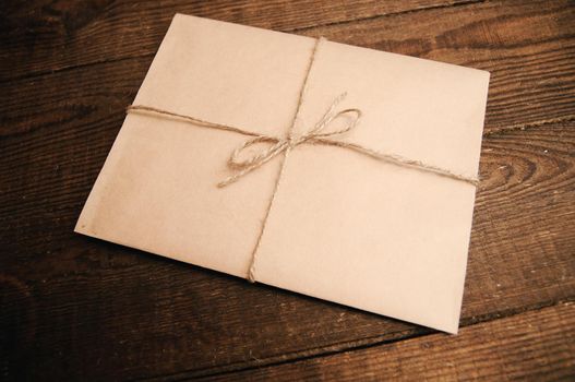 Correspondence from kraft paper on a wooden background tied with a rope