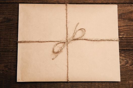 Correspondence from kraft paper on a wooden background tied with a rope