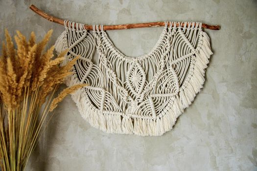 Wall panel in the style of Boho made of cotton threads in natural color using the macrame technique for home decor and wedding decoration. Beautiful boho macrame wall panel will add a cozy atmosphere and charm to any space in your home