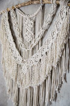 Wall panel in the style of Boho made of cotton threads in natural color using the macrame technique for home decor and wedding decoration. Beautiful boho macrame wall panel will add a cozy atmosphere and charm to any space in your home