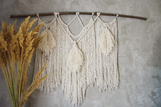 Wall panel in the style of Boho made of cotton threads in natural color using the macrame technique for home decor and wedding decoration. Beautiful boho macrame wall panel will add a cozy atmosphere and charm to any space in your home